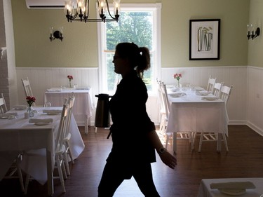 A server is silhouetted in the dining room as the Opinicon Resort is up and running after a major renovation and restoration over the last two and half years.