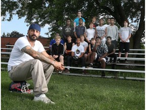 Geoff Woodhouse, president of North Gloucester Giants, poses for a photo with his Giants football team on Monday July 17, 2017. About six weeks ago, someone broke into the field house that is the HQ for the North Gloucester Giants football team. They vandalized the place and stole about $17,000 worth of equipment.