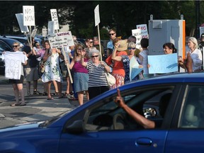 Demonstrators voice their discontent with a Salvation Army plan to bring a shelter to Vanier.