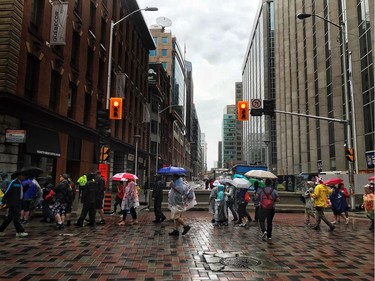 The line up to go through security checks stretches down Bank Street and through an intersection as crowds head to Parliament Hill July 1, 2017.