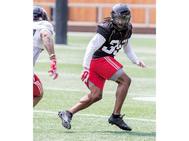 Defensive back CJ Roberts (R) covers a receiver as the Ottawa Redblacks practice at TD Place.