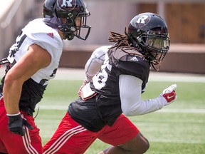 Defensive back CJ Roberts (R) covers a receiver as the Ottawa Redblacks practice at TD Place.
