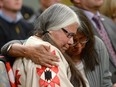 Lorna Standingready is comforted by a fellow survivor in the audience during the closing ceremony of the Indian Residential Schools Truth and Reconciliation Commission, at Rideau Hall in Ottawa, on June 3, 2015.