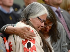 Residential school survivor Lorna Standingready is comforted by a fellow survivor during the closing ceremony of the Indian Residential Schools Truth and Reconciliation Commission, at Rideau Hall June 3, 2015. Who should have rights to the confidential records of school survivors?