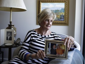 Rita Bisson's late husband François was a resident at the Garry J. Armstrong long-term care facility. She sat for a portrait, holding a cherished photograph, with paintings by François hanging on the wall in her apartment on July 5, 2017.