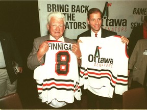 Frank Finnigan, left, and Bruce Firestone show a prototype Ottawa Senators' jersey in this September 1989 file photo. Bruno Schlumberger/Ottawa Citizen/Postmedia Network ORG XMIT: POS2015120112330349

sprt-26-d4fir c menary