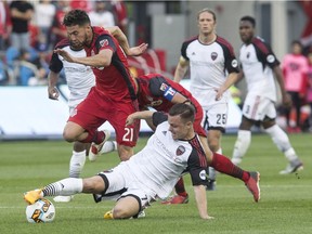 Fury FC's Ryan Williams battles for the ball with Toronto FC's Jonathan Osorio during a Canadian Championship semifinal contest at Toronto on May 31. THE CANADIAN PRESS/Chris Young