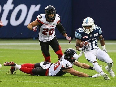 Marlese Jackson of the Toronto Argos gets away from Dan West of the Ottawa Redblacks at BMO field in Toronto during CFL action in Toronto, Ont. on Monday July 24, 2017.