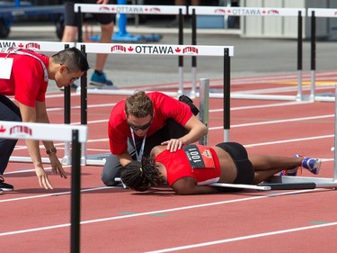 Heptathlete Anya Akili lies on the track after landing awkwardly on her leg while competing in the 100m hurdles as the Canadian Track and Field Championships get underway at the Terry Fox Athletic Facility.