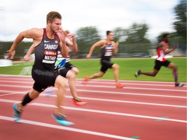 Decathletes including Joshua Mather (L) are a blur of speed while racing in the 100m sprint as the Canadian Track and Field Championships get underway at the Terry Fox Athletic Facility.