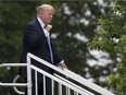 U.S. President Donald Trump reacts to the crowd as he leaves his viewing box at the U.S. Women's Open on Friday. AP Photo/Carolyn Kaster