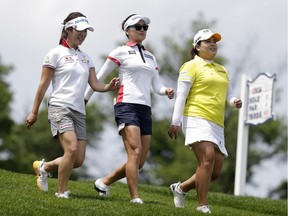 South Korean golfers Seung Hyun Lee, left, So Yeon Ryu, center, and Inbee Park walk the course after teeing off the 13th hole during a practice round at the U.S. Women's Open Golf Championship at Trump National Golf Club in Bedminster, N.J., Wednesday, July 12, 2017.