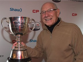 Former Ottawa Rough Rider quarterback Russ Jackson poses with the Grey Cup during a ceremony in 2016.  Wayne Cuddington/ Postmedia