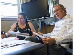 Ottawa Inner City Health's Wendy Muckle, left, and Dr. Jeff Turnbull discuss some of the patients they'll be visiting during morning rounds in Ottawa Thursday, August 3, 2017.