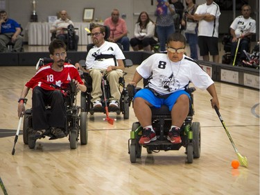 Malaky Lamberson, No. 8, of the Ottawa Black Aces goes wide on Mike Mifflin of Team Canada. The Canadian Electric Wheelchair Hockey Association (CEWHA) 2017 Nationals took place at Carleton University Raven's Nest Saturday August 5, 2017. #8  Ashley Fraser/Postmedia
Ashley Fraser, Postmedia