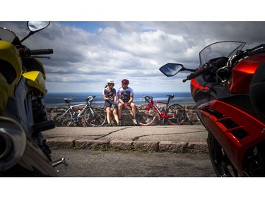 Melanie Desjardins and Stephane Coutlee take a break on the wall after biking up to Champlain Lookout on Sunday.   Ashley Fraser/Postmedia