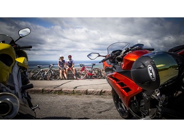 Melanie Desjardins and Stephane Coutlee take a break on the wall after biking up to Champlain Lookout on Sunday.   Ashley Fraser/Postmedia