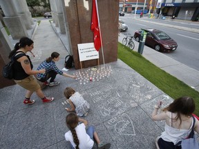 People gather at the Human Rights Monument in Ottawa on Sunday, August 13, 2017, in support of those injured and killed yesterday in Charlottesville, Virginia.