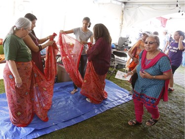 A sari tying demonstration at the South Asian Festival at City Hall in Ottawa on Sunday, August 13, 2017.