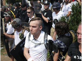 White nationalists, neo-Nazis and members of the "alt-right" exchange insults with counter-protesters as they attempt to guard the entrance to Lee Park during the "Unite the Right" rally Aug. 12 in Charlottesville, Va.