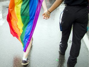 Two people march in Ottawa's 2016 Pride parade. Ashley Fraser, Postmedia