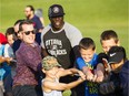 Ottawa city Coun.Mathieu Fleury, left, and Ottawa Redblacks player Ron Omara help some young North Gloucester Giants players in a tug o' war after a ceremony to mark an equipment donation by Mattamy Homes to the North Gloucester Giants football team.