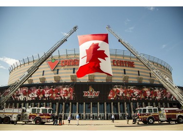 Ottawa firefighters fly a large Canada flag outside the Canadian Tire Centre during a celebration of life service for former Ottawa Senators general manager and coach, Bryan Murray, Thursday, August 24, 2017.(