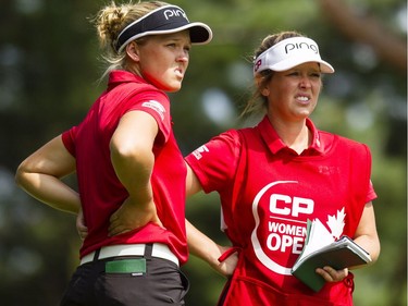 Brooke Henderson, left, chats with her sister and caddy, Brittany Henderson, during the second round of the CP Women's Open at the Ottawa Hunt and Golf Club in Ottawa Friday, August 25, 2017.