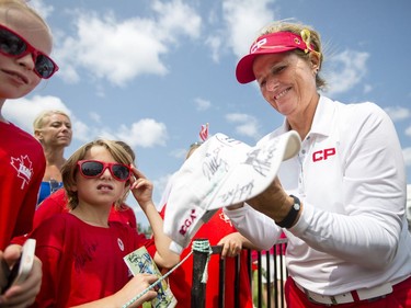 Lori Kane, right, signs autographs for some young fans after finishing the second round of the CP Women's Open at the Ottawa Hunt and Golf Club in Ottawa Friday, August 25, 2017.