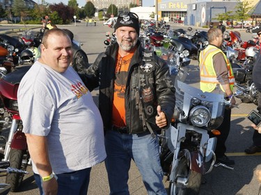 Raymond Vanneste, left, and Dan "Big Dog" Lapage pose for a photo at the "Bikers Against Violence - Cruise Don't Bruise" 8th annual motorcycle ride in Ottawa on Saturday, August 26, 2017.