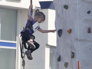 Kids take part in a wall climbing demonstration at the Westboro Fuse street festival in Ottawa on Saturday, August 26, 2017.