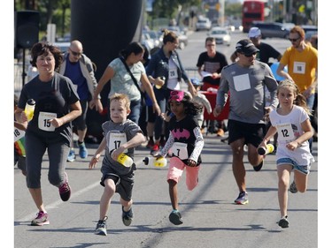 Kids take part in a relay race at the Westboro Fuse street festival in Ottawa on Saturday, August 26, 2017.