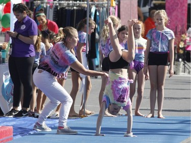 Kids take part in a gymnastics demonstration at the Westboro Fuse street festival in Ottawa on Saturday, August 26, 2017.