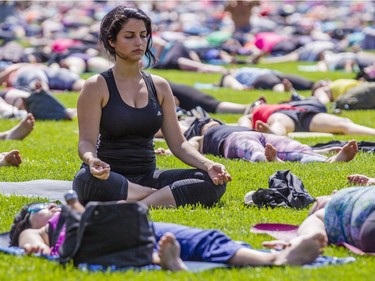 Lara Dagher meditates as hundreds of people take part in the last yoga on Parliament Hill event hosted by Lululemon Athletica Wednesday, August 30, 2017.