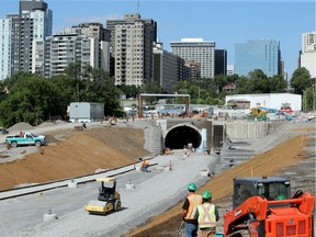 Construction workers in front of the tunnel where the new LRT will come through at the Pimisi Station on July 27, 2017.