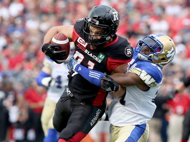 Ottawa's Patrick Lavoie runs into Winnipeg's Moe Leggett during first-half action in Friday's game. Julie Oliver/Postmedia