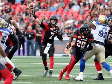 Redblacks QB Trevor Harris unloads during first-half action against the Bombers on Friday night. Julie Oliver/Postmedia