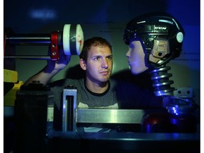 David Koncan, a Phd candidate in the Neurotrauma Impact Science lab at the University of Ottawa, measures impact on a head with a linear impactor machine.