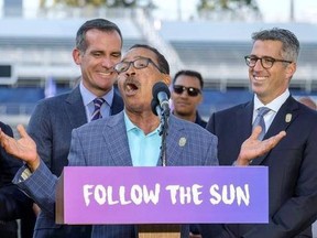 os Angeles Mayor Eric Garcetti, left, and L.A. Olympic Committee leader Casey Wasserman, right, react as City Council President Herb Wesson speaks during a press conference to make an announcement for the city to host the Olympic Games and Paralympic Games 2028, at StudHub Center in Carson, outside of Los Angeles, Calif., Monday, July 31, 2017.