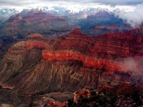 This Jan. 20, 2001, file photo, shows the Kaibab Trail, running right to left in the center, at the Grand Canyon National Park. A Grand Canyon National Park spokeswoman says a body believed to be a missing 38-year-old Texas woman was found less than 450 yards (410 meters) from a trail in the bottom of the canyon on Wednesday, Aug. 2, 2017. The body believed to be Sarah Beadle of Fort Worth, Texas. Beadle was reported missing on Tuesday.