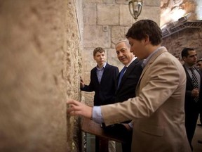 FILE - In this Jan. 22, 2013 file photo, Israeli Prime Minister Benjamin Netanyahu, center, prays with his sons Yair, background, and Avner, right, at the Western Wall, the holiest site where Jews can pray, in Jerusalem&#039;s Old City.Netanyahu&#039;s 26-year-old son Yair has been saddled with the image of undeserved privilege since becoming an adult _ someone who hobnobs with world leaders, has received extravagant gifts from a billionaire and enjoys a state-funded driver and bodyguard. But recent crude