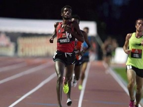 Mohammed Ahmed, of St. Catharines, Ont., crosses the finish line to win the 5,000-metre race at the Canadian Track and Field Championships, in Ottawa, Thursday, July 6, 2017. Ahmed will give Canada its first shot at a medal in the men&#039;s 10,000 metres on the opening day of the world track and field championships. THE CANADIAN PRESS/Fred Chartrand