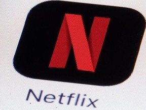This Monday, July 17, 2017, photo shows the Netflix logo on an iPhone in Philadelphia. Netflix says it made its first acquisition Monday, Aug. 7, 2017, buying the comic book publisher Millarworld. Millarworld‚Äôs graphic novels ‚ÄúKick-Ass,‚Äù ‚ÄúWanted‚Äù and ‚ÄúKingsman‚Äù were all turned into movies, and Netflix plans to create more films and shows featuring Millarworld characters for its video streaming service. Netflix did not say how much it paid for Millarworld. (AP Photo/Matt Rourke)