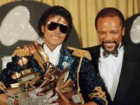 FILE - In this Feb. 28, 1984, file photo, Michael Jackson, left, holds eight awards as he poses with Quincy Jones at the Grammy Awards in Los Angeles. Jackson&#039;s estate announced Aug. 7, 2017, that a 3-D version of his iconic &ampquot;Thriller&ampquot; video will debut at the Venice Film Festival, which begins Aug. 30. (AP Photo/Doug Pizac, File)