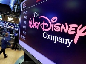 In this Monday, Aug. 7, 2017, photo, The Walt Disney Co. logo appears on a screen above the floor of the New York Stock Exchange. The Walt Disney Co. reports earnings, Tuesday, Aug. 8, 2017.