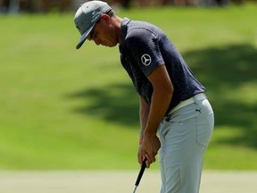 Rickie Fowler watches his putt on the second hole during the first round of the PGA Championship golf tournament at the Quail Hollow Club Thursday, Aug. 10, 2017, in Charlotte, N.C. (AP Photo/Chuck Burton)