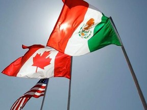 In this April 21, 2008 file photo, national flags of the United States, Canada, and Mexico fly in the breeze in New Orleans. Chrystia Freeland will give a speech Monday arguing that NAFTA&#039;s upcoming renegotiation will benefit a broad cross section of Canadians.