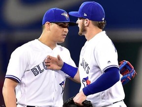 Toronto Blue Jays third baseman Josh Donaldson, right, and teammate Roberto Osuna celebrate their win following ninth inning American league baseball action against the Tampa Bay Rays, in Toronto on Monday, August 14, 2017. THE CANADIAN PRESS/Frank Gunn