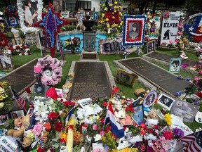 Flowers, signs, and other tributes left by fans fill the meditation garden where Elvis Presley is buried alongside his parents and grandmother at Graceland, Presley&#039;s Memphis home, on Tuesday, Aug. 15, 2017, in Memphis, Tenn. Fans from around the world are at Graceland for the 40th anniversary of his death. Presley died Aug. 16, 1977.(AP Photo/Brandon Dill)