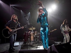 Tragically Hip frontman Gord Downie, centre, leads the band through a concert in Vancouver, Sunday, July 24, 2016. A new biography on the Tragically Hip and band frontman Gord Downie will be published in 2018. THE CANADIAN PRESS/Jonathan Hayward